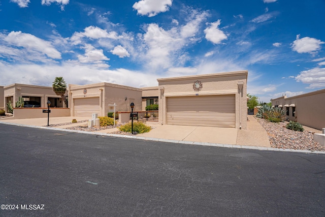 pueblo-style home featuring a garage