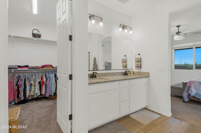 bathroom with ceiling fan, hardwood / wood-style floors, and double sink vanity