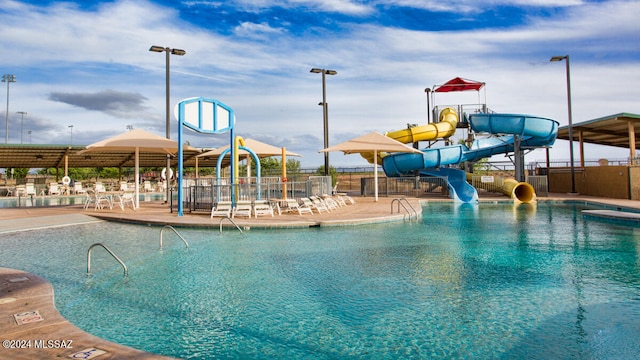 view of swimming pool with a water slide