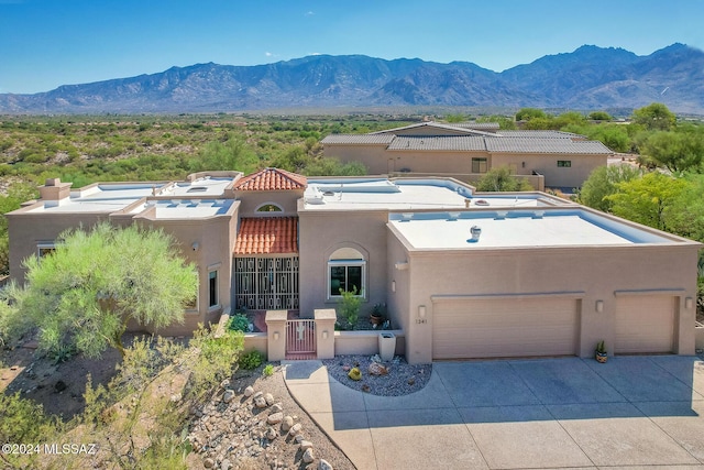 view of front facade featuring a mountain view and a garage