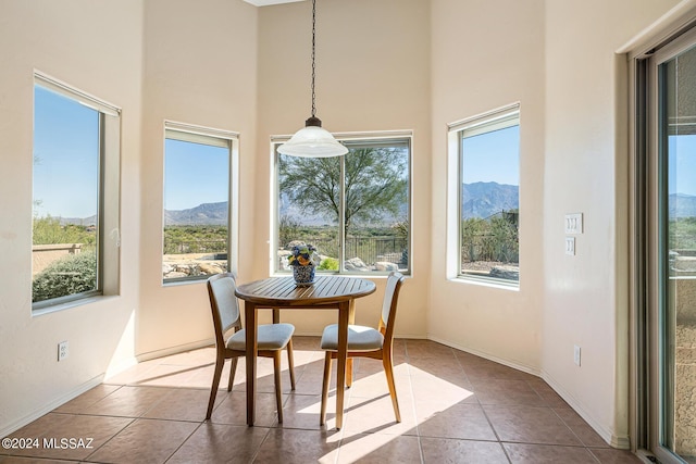 sunroom / solarium featuring a mountain view and a healthy amount of sunlight