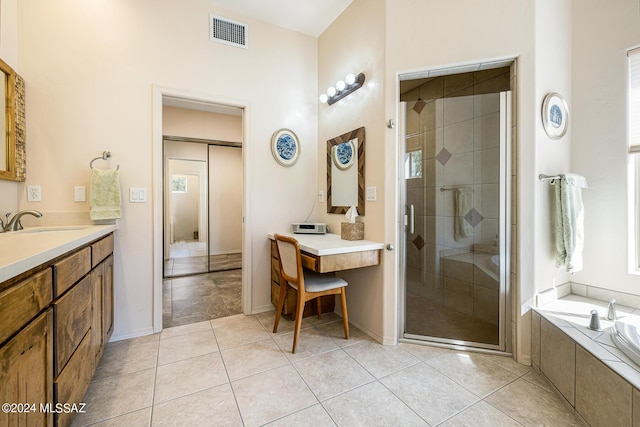 bathroom with tile patterned floors, vanity, and independent shower and bath