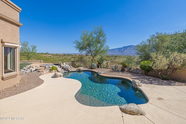 view of swimming pool featuring a mountain view and a patio