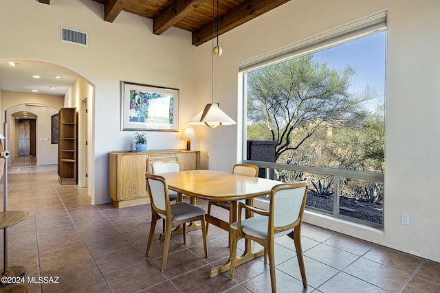 tiled dining area with beamed ceiling and wood ceiling