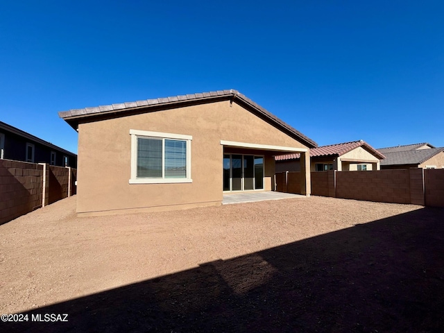 rear view of property featuring a patio area