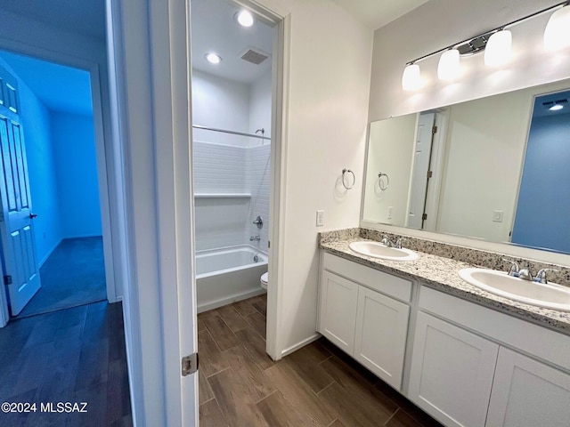 full bathroom featuring shower / bathing tub combination, vanity, wood-type flooring, and toilet