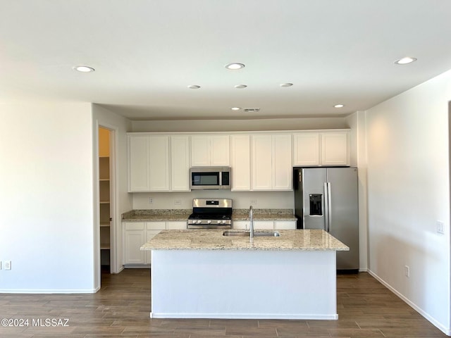 kitchen with white cabinets, hardwood / wood-style floors, stainless steel appliances, and sink