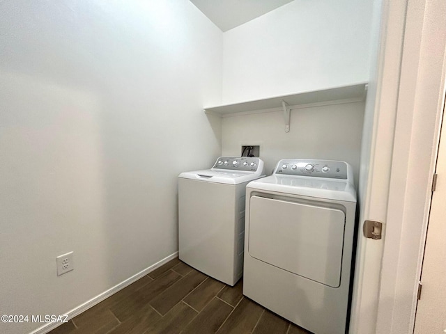 laundry room with washer and clothes dryer and dark wood-type flooring