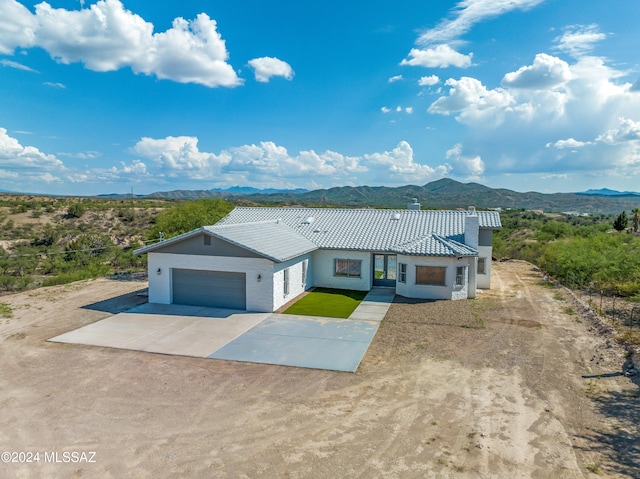 view of front of house with a garage and a mountain view