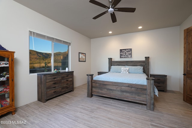 bedroom with light hardwood / wood-style floors and ceiling fan