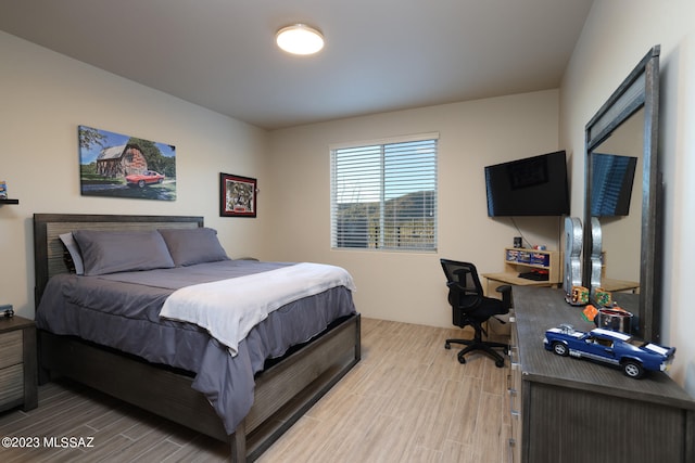 bedroom with hardwood / wood-style floors