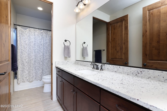 full bathroom with vanity, toilet, and shower / tub combo