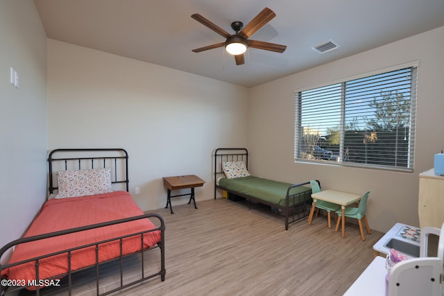 bedroom with ceiling fan and light hardwood / wood-style flooring