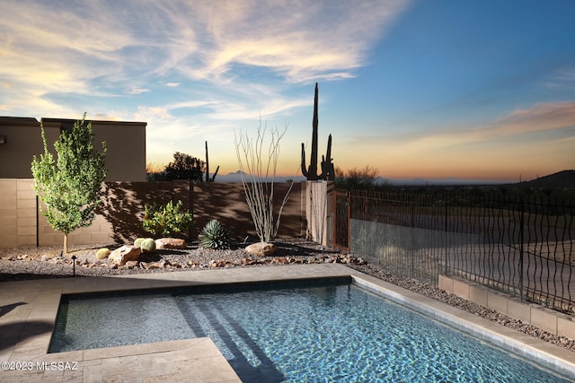 view of pool at dusk