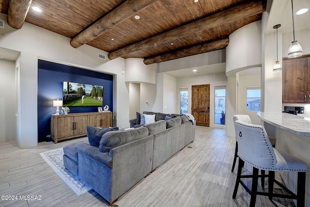 living room with beamed ceiling, wood ceiling, and light wood-type flooring