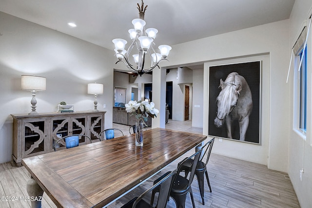 dining area with a chandelier and light hardwood / wood-style floors