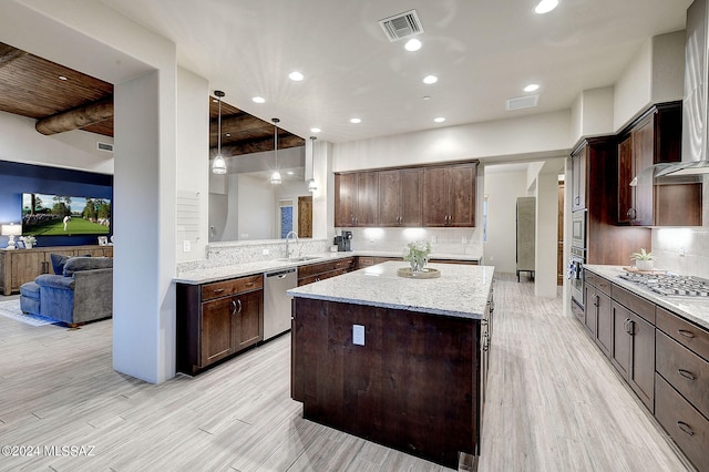 kitchen featuring dark brown cabinets and light wood-type flooring