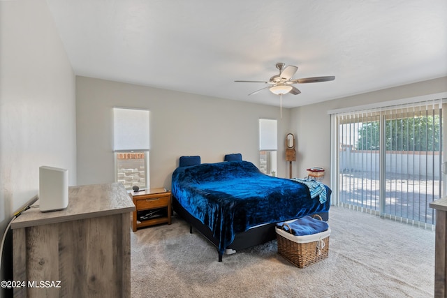 carpeted bedroom with access to exterior and ceiling fan