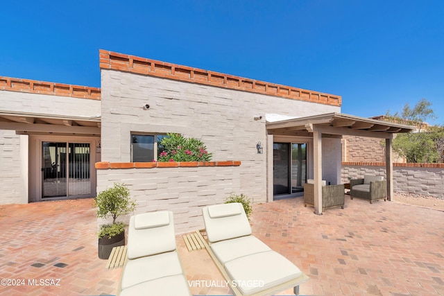 back of house with a patio area and an outdoor hangout area