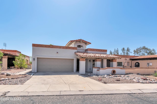 mediterranean / spanish-style home featuring a garage