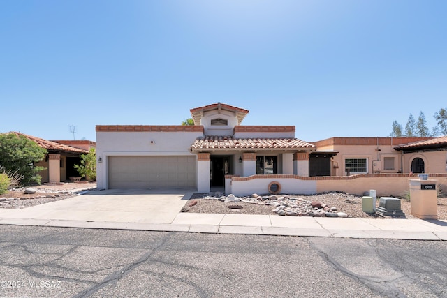 mediterranean / spanish home featuring a garage