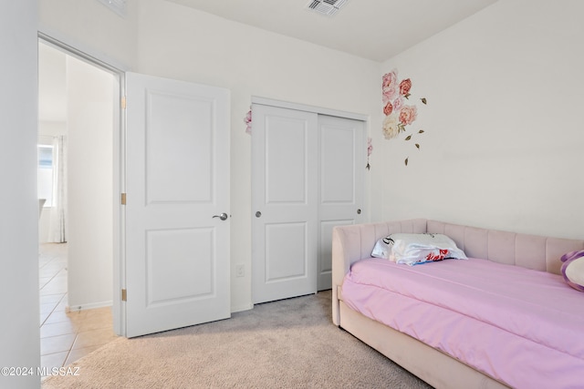 carpeted bedroom with a closet