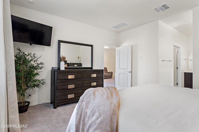 carpeted bedroom with ensuite bath