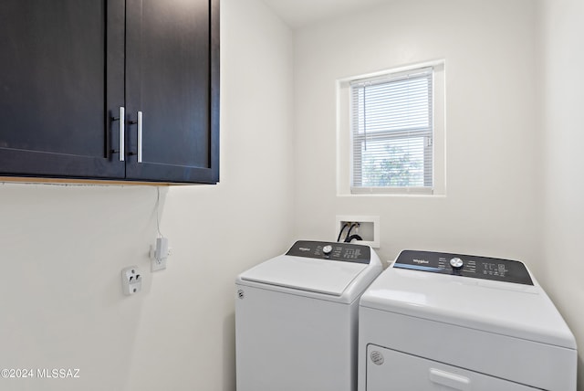 washroom featuring cabinets, independent washer and dryer, and hookup for a washing machine