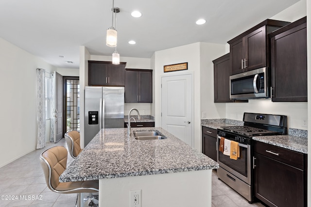 kitchen featuring sink, a kitchen island with sink, light tile floors, and stainless steel appliances