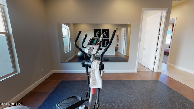 exercise room featuring dark tile patterned flooring