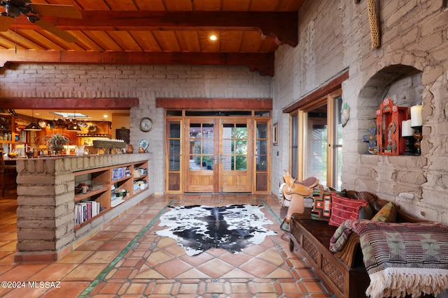 interior space featuring tile patterned flooring, wooden ceiling, and beamed ceiling