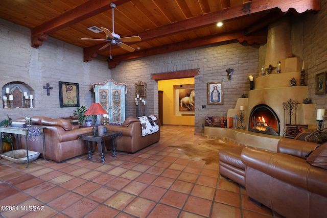 tiled living area featuring wooden ceiling, beamed ceiling, a warm lit fireplace, and brick wall