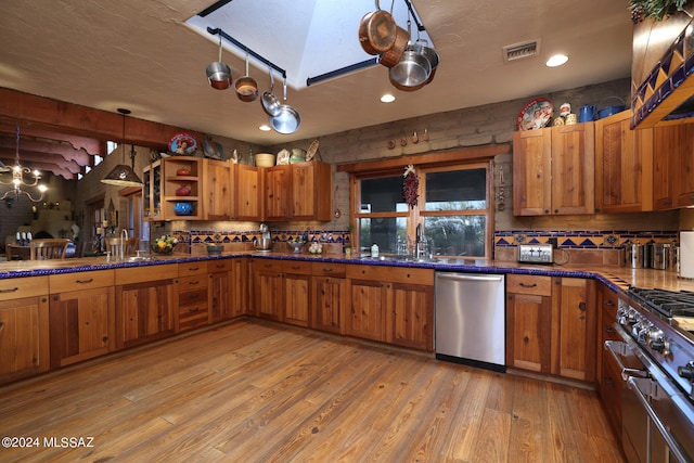 kitchen featuring open shelves, appliances with stainless steel finishes, brown cabinetry, tasteful backsplash, and visible vents
