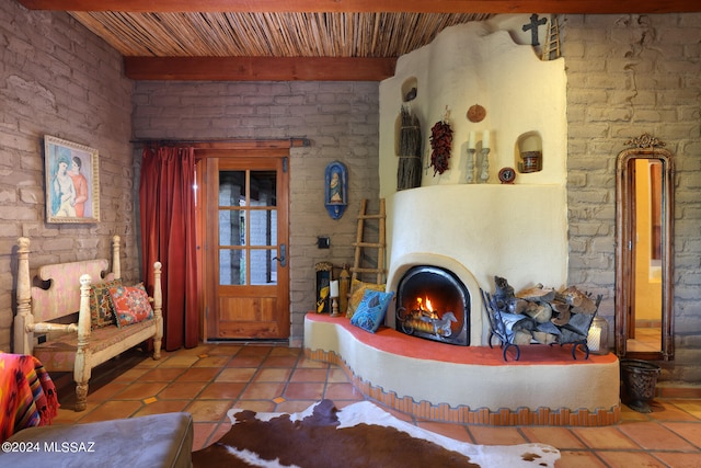 tiled living room featuring wood ceiling and beamed ceiling