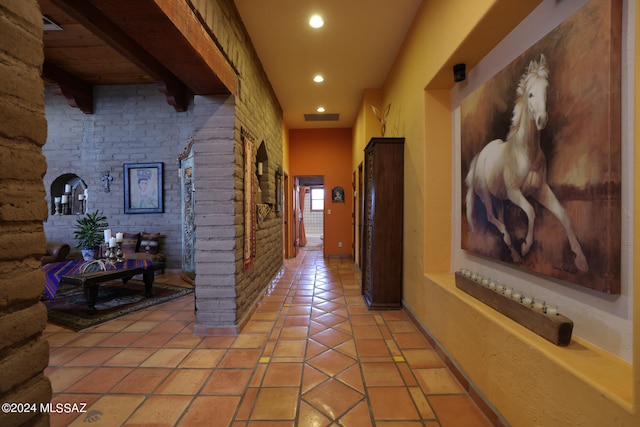 hallway featuring light tile patterned floors, baseboards, recessed lighting, and visible vents