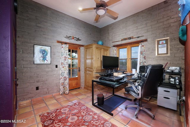 office space with a ceiling fan and light tile patterned floors