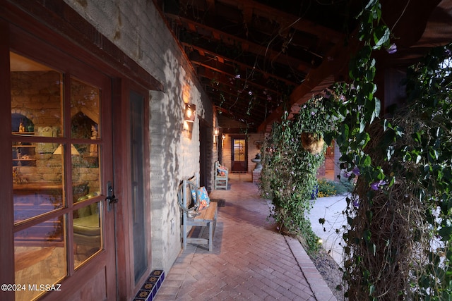 exterior space with a patio area and stone siding
