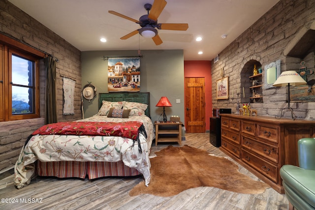 bedroom with a ceiling fan, recessed lighting, and wood finished floors