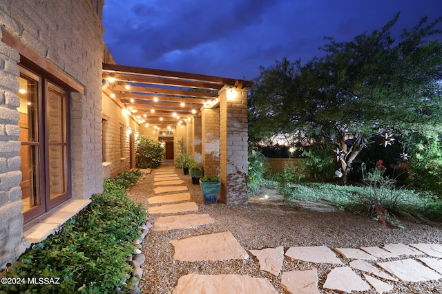 yard at twilight featuring a pergola