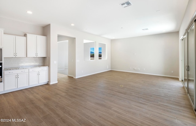 unfurnished living room with light hardwood / wood-style flooring