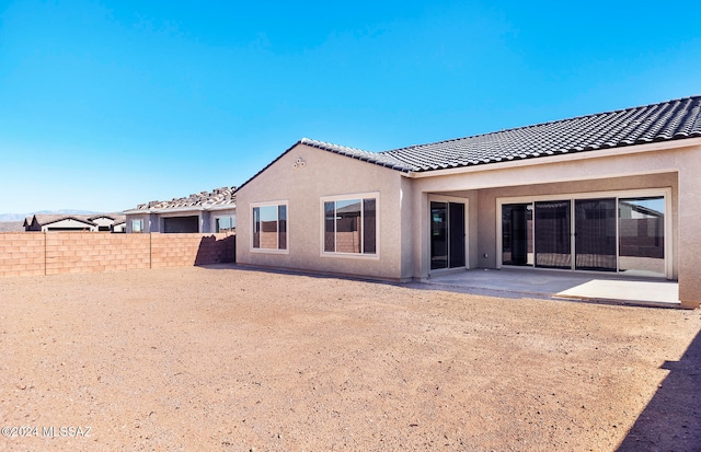 back of property featuring a patio