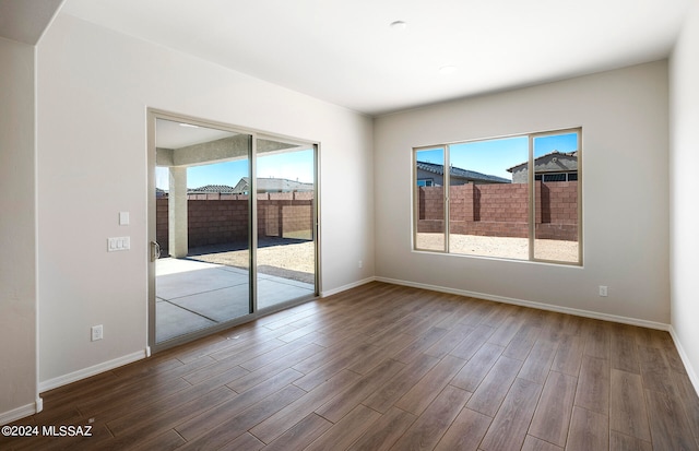 empty room with dark hardwood / wood-style flooring