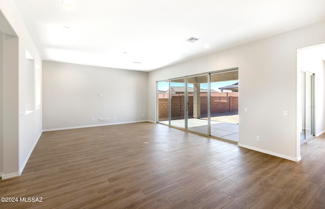 empty room with dark hardwood / wood-style floors