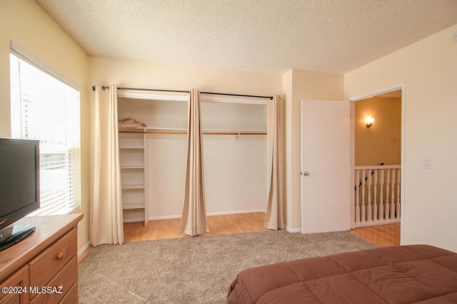 carpeted bedroom featuring a textured ceiling