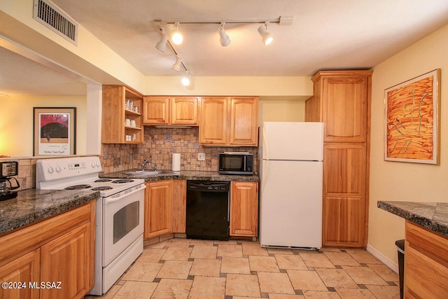 kitchen with decorative backsplash, white appliances, and sink