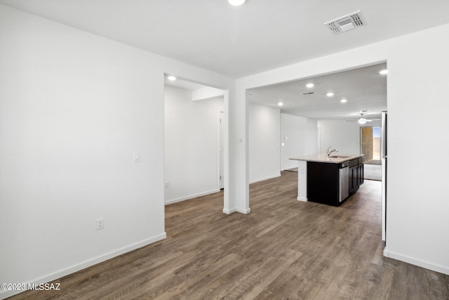 unfurnished living room with sink, ceiling fan, and dark hardwood / wood-style flooring