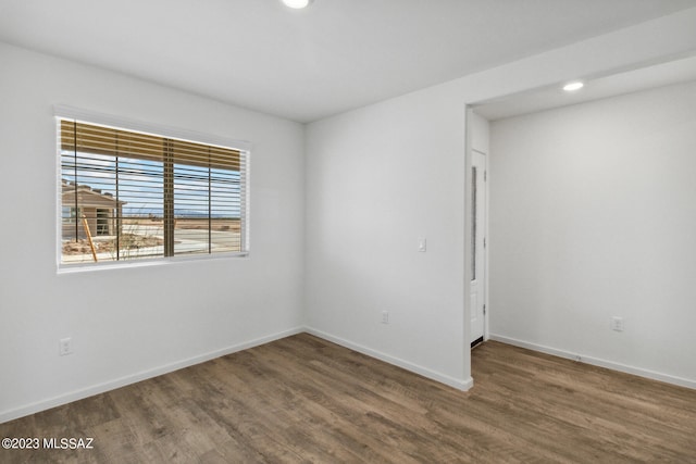 empty room with dark hardwood / wood-style floors