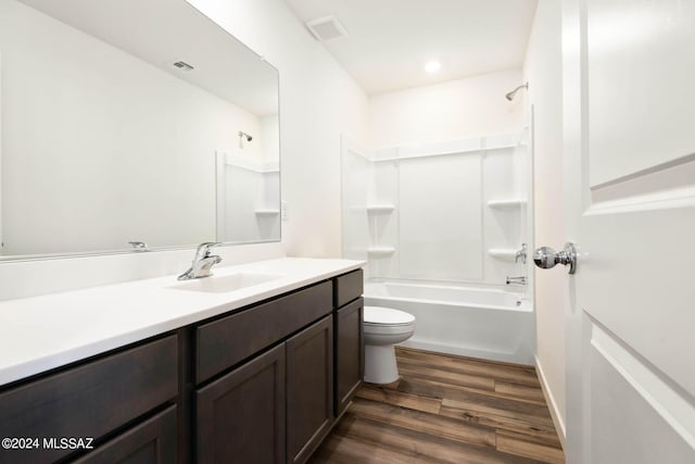 full bathroom featuring toilet, vanity, tub / shower combination, and hardwood / wood-style flooring