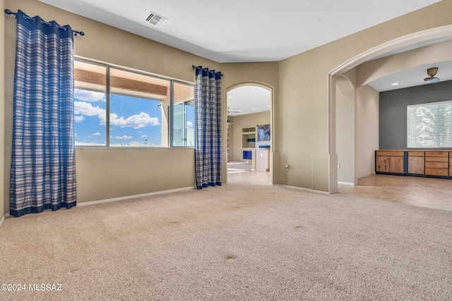 empty room with ceiling fan and carpet flooring