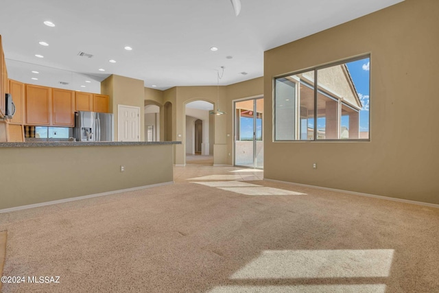 unfurnished living room with light carpet